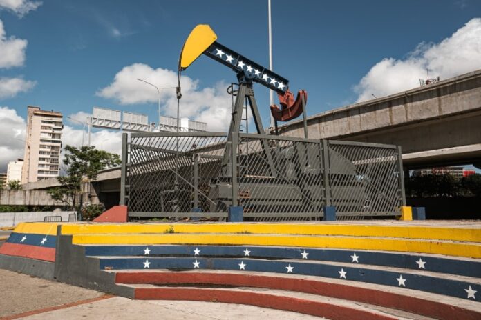 Oil giant Chevron confirmed that it will expand operations in Venezuela after President Donald Trump announced an ambitious deal to develop the nation’s oil reserves and give the Pentagon a stake in the profits.
Chevron, the only U.S. oil company with a major presence in Venezuela, said Wednesday that it has been assigned additional acreage in the Orinoco Belt, where it has active operations. The company plans to invest more than $7 billion over the next five years, with the goal of more than doubling its current production to about 600,000 barrels a day.
“Chevron’s history in Venezuela spans more than a century, and our expanded position reflects our confidence in the country’s deep resource potential,” CEO Mike Wirth said in a prepared statement.
Venezuela holds the world’s largest proven reserves, totaling more than 303 billion barrels of crude oil, according to OPEC’s 2025 Annual Statistical Bulletin. Saudi Arabia is a distant second with 267 billion barrels.
Yet because Venezuela’s energy infrastructure is severely degraded and the nation is operating under international sanctions, its daily production is just over 1 million barrels, compared with the 10 million to 11 million barrels that Saudi Arabia produces each day. The U.S. produces almost 14 million barrels per day.
Venezuela holds the world’s largest proven reserves, totaling more than 303 billion barrels of crude oil, according to OPEC’s 2025 Annual Statistical Bulletin.Diko Betancourt / Anadolu via Getty Images
Chevron, the second-largest U.S. oil company, has had a presence in Venezuela since 1923.
U.S. Energy Secretary Chris Wright on Wednesday attended a ceremony in Venezuela’s capital in which Chevron, Italian oil company Eni and other energy companies signed agreements with the South American country’s government.
“President Trump’s mission in Venezuela is straightforward. The mission is to bring peace, freedom, opportunity and prosperity to the people of Venezuela,” Wright said in Caracas. “I believe the deals that are signed today — tens of billions of dollars of investment, ultimately many thousands of jobs — are critical in starting this ball rolling of peace, opportunity and prosperity for everyone in Venezuela.”
The White House confirmed Monday that it is partnering with North American Blue Energy Partners, NABEP, as part of Trump’s push to tap into Venezuela’s oil industry.
Yet the agreement has been met with skepticism from energy experts who say it will take years to revive Venezuela’s oil industry, which is in disarray after years of neglect.
There are also questions about whether Venezuela’s acting president, Delcy Rodríguez, has the authority to give NABEP 100-year rights over 17 oil fields with reserves of 65 billion barrels — and whether future Venezuelan or American administrations would overturn the agreement.
An oil tanker is anchored in Lake Maracaibo in Cabimas, Venezuela, on Monday. Ariana Cubillos / AP
Venezuela’s constitution states that arrangements like the one that the United States has entered must be approved by the National Assembly, which has not happened, wrote Ian Vásquez, vice president for international studies at the Cato Institute.
“The deal lacks legitimacy since it was agreed to with a dictatorship that has clung to power for decades through violence and by committing what was probably the largest electoral fraud in Latin American history in 2024,” Vásquez wrote. “The agreement was also reached under overwhelming pressure, military and otherwise, from the United States. As such, any future Venezuelan democracy will question the deal, thus undermining confidence in the current arrangement.”
The ruling party-controlled National Assembly expressed support for the agreement during its Tuesday session, but lawmakers held no debate or voted to approve it.
Wright on Wednesday pushed back on criticism, telling reporters that the deal is “a massive win” for both countries.
“Because what it’s going to do is take resources that are underground, not helping anyone, and invest capital and money and technology and bring them to the surface to better the lives of Venezuelans, better supply energy to Americans,” Wright said during a joint press conference with Rodríguez.
Trump has eyed Venezuela’s oil since the January capture of then-President Nicolás Maduro and has pressed to get U.S. businesses back into the country. “We have Exxon going in, we have Chevron going in. We have our big oil companies going in,” he said that same month.
He suggested again on Monday that other U.S. oil majors were preparing for a return, though other than Chevron, there is no evidence of that.
Exxon Mobil CEO Darren Woods said in January that Venezuela was “uninvestable.” An Exxon spokesman said this week that “nothing has changed.”
Venezuela nationalized its oil industry in 1976 and created the state-owned company Petróleos de Venezuela S.A. A second nationalization occurred in 2007, when President Hugo Chávez pushed foreign oil companies into state-controlled joint ventures. Ronaldo Schemidt / AFP via Getty Images
The history of U.S. oil majors in Venezuela explains the hesitation.
Venezuela nationalized its oil industry in 1976 and created the state-owned company Petróleos de Venezuela S.A. A second nationalization occurred in 2007, when President Hugo Chávez pushed foreign oil companies into state-controlled joint ventures and seized the assets of companies that refused. Chevron agreed to a joint venture. Others, including Exxon and ConocoPhillips, refused, and Venezuela took their assets.
Trump has said that the agreement with Venezuela would “substantially lower” gasoline prices in the U.S. However, analysts have repeatedly warned that Venezuela’s dilapidated oil infrastructure will require years of restoration work and tens of billions of dollars to resuscitate.
“It could take 2 to 4 years to get new greenfield facilities online in the Orinoco region,” Amy Jaffe, director of the Global Energy, Climate, and Sustainability Lab at New York University, said in an email. “Other places where there is no pipeline and other kinds of support infrastructure could take longer.”
Meanwhile, the national average price for a gallon of regular gasoline jumped overnight to $4.12, according to the motor club AAA. That is 93 cents more than it cost at this point last year.
This post appeared first on https://www.nbcnews.com