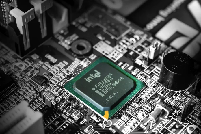 The tired framing of Intel is the fallen giant that missed mobile, missed AI, and handed its manufacturing crown to Taiwan. That story is two years out of date. Intel (NASDAQ: INTC) closed at $128.76 on June 26, 2026 after a turnaround run that has lifted the stock nearly 500% under chief executive Lip-Bu Tan (<a href="https://fortune.com/2026/06/03/intel-ceo-lip-bu-tan-ai-semiconductors-innovation/">Fortune</a>), and the real question for a 2026 price forecast is no longer survival — it is whether the foundry bet converts. My read, having tracked the foundry wars through the 18A delays and the CHIPS Act drama, is that the entire bull-bear range, from a $150 bull case to a roughly $90 bear case, comes down to one binary the income statement cannot answer: does a marquee external customer commit real volume to Intel's most advanced nodes, or does Intel stay a captive fab that mostly serves itself?
That is the angle most INTC coverage misses. After a near-500% move, the turnaround narrative is already in the price; what is not yet priced is the answer to a single yes/no. It mirrors the setup at the company that overtook Intel: in our <a href="https://financefeeds.com/tsmc-stock-forecast-590-bull-330-bear-2026/">TSMC stock forecast</a>, the bull-bear gap was almost entirely a geopolitics term. At Intel, the gap is a customer-commitment term. Strip out the question of whether Nvidia, AMD or another fabless leader signs up for 18A or 14A in volume, and the stock is a reasonably valued recovery story. Make that question the centre of the thesis — as the market has — and the $60 spread between bull and bear is simply the odds the market assigns to Intel Foundry winning a name everyone recognises.
<strong>Key Facts:</strong>
<blockquote>
• INTC closed at $128.76 on June 26, 2026, after a roughly 500% run under CEO Lip-Bu Tan — <a href="https://fortune.com/2026/06/03/intel-ceo-lip-bu-tan-ai-semiconductors-innovation/">Fortune</a>
• The US government holds a 9.9% passive stake via an $8.9bn investment — <a href="https://www.manufacturingdive.com/news/us-government-10-percent-stake-intel-chips-funding-8-9-billion/758518/">Manufacturing Dive</a>
• Microsoft has committed to Intel's 18A node; Nvidia has tested it via multi-project wafer runs without committing volume — <a href="https://www.trendforce.com/news/2026/06/09/news-intel-foundry-gains-momentum-as-google-reportedly-orders-3m-tpus-nvidia-evaluates-18a-for-multi-die-gpu-design/">TrendForce</a>
• Bullish targets cluster near $150 (Melius Research, Benchmark) versus an analyst low estimate of $45 — <a href="https://www.marketbeat.com/stocks/NASDAQ/INTC/forecast/">MarketBeat</a>
• Consensus rating is Hold across 31 analysts as of June 23, 2026 — <a href="https://www.marketbeat.com/stocks/NASDAQ/INTC/forecast/">MarketBeat</a>
• Goldman Sachs initiated at Neutral with a $150 target — <a href="https://www.marketbeat.com/stocks/NASDAQ/INTC/forecast/">MarketBeat</a>
</blockquote>
What is actually happening — and why the foundry is the whole story
Intel runs two businesses bolted together: a product company that designs and sells CPUs, and Intel Foundry, the contract-manufacturing arm meant to compete with Taiwan Semiconductor Manufacturing Company (TSMC) and Samsung for outside chip orders. The product side is recovering, but it is the foundry that justifies the re-rating. The pivotal node is 18A, Intel's first leading-edge process using gate-all-around transistors and backside power delivery, now ramping, with the next-generation 14A behind it.
The logic is simple: a foundry only earns a TSMC-style multiple if external customers — companies that design chips but do not own fabs — trust it with their flagship products. So far the scorecard is mixed. Microsoft has committed to 18A. Google has reportedly placed large orders in the broader ecosystem. But Nvidia, the most important potential customer of all, has tested 18A through low-risk multi-project wafer runs without committing high-volume production, and reports have swirled about Intel potentially de-emphasising 18A for external use in favour of 14A. The difference between "captive fab" and "TSMC rival" is exactly this list of names, which is why every foundry headline moves the stock more than any CPU launch. The same external-customer dynamic shapes the memory cycle covered in FinanceFeeds' <a href="https://financefeeds.com/micron-stock-price-prediction-385-2000-mu-scenarios/">Micron stock price prediction</a>.
Underneath the foundry story sits an operational reset that made the re-rating possible in the first place. Since taking over, Lip-Bu Tan has stripped out management layers — reportedly halving them — and refocused the company on engineering and cost discipline, the changes credited with the stock's near-500% recovery (<a href="https://fortune.com/2026/06/03/intel-ceo-lip-bu-tan-ai-semiconductors-innovation/">Fortune</a>). That matters for the forecast because a leaner cost base lowers the bar for the foundry to reach break-even: every point of yield improvement on 18A drops further toward the bottom line than it would have under the old structure. The product business — client and data-centre CPUs — is the cash engine funding the foundry build-out, so its stabilisation is the quiet precondition for the whole bull case. Without the cost reset, Intel could not afford to qualify two leading-edge nodes at once while carrying record capital intensity.
<blockquote>
"We are embracing our roots as data driven, paranoid, and engineering driven."
— <strong>Lip-Bu Tan</strong>, Chief Executive Officer at Intel (<a href="https://fortune.com/2026/04/23/intel-went-back-to-its-roots-paranoid-earnings-shares-ceo-lip-bu-tan/">Fortune</a>)
</blockquote>
The bull case: how INTC reaches $150
The bull thesis rests on three legs. First, sponsorship: the US government's 9.9% passive stake, taken through an $8.9bn investment, plus the political imperative to onshore advanced manufacturing, give Intel a strategic backstop no other chipmaker enjoys. Second, technology: if 18A yields hold and 14A arrives on schedule, Intel can credibly offer a US-based leading-edge alternative to Taiwan, exactly the diversification hyperscalers and defence customers say they want. Third, customers: Microsoft is already aboard, defence clients are signing, and even a partial Nvidia or AMD commitment would re-rate the foundry overnight.
Wall Street's bulls have put numbers on it. Melius Research and Benchmark both carry $150 targets, and Goldman Sachs initiated coverage at $150, albeit with a Neutral rating that captures the execution risk (<a href="https://www.marketbeat.com/stocks/NASDAQ/INTC/forecast/">MarketBeat</a>). The mechanism to $150 is a re-rating, not just earnings: a single blue-chip foundry commitment would let the market value Intel Foundry as a genuine TSMC competitor rather than a cost centre. Crucially, management is refusing to chase that re-rating by over-promising.
<blockquote>
Intel will qualify its 18A and 14A nodes "one step at a time" before deciding whether to use them for outside customers.
— <strong>Lip-Bu Tan</strong>, Chief Executive Officer at Intel, at the press conference on the Nvidia partnership (<a href="https://www.trendforce.com/news/2026/06/09/news-intel-foundry-gains-momentum-as-google-reportedly-orders-3m-tpus-nvidia-evaluates-18a-for-multi-die-gpu-design/">TrendForce</a>)
</blockquote>
Market impact and the data: a stock priced for the next catalyst
Here is the data synthesis that frames the call. After a near-500% run, INTC at $128.76 is no longer a deep-value turnaround; it is a momentum stock priced for the foundry thesis to keep delivering. The clearest evidence is the spread of analyst opinion itself: a Hold consensus across 31 analysts, bullish targets near $150, and a low estimate of $45 — a range so wide it is really two different companies. One is a US foundry champion worth a premium; the other is a struggling product company losing share. The market is currently splitting the difference.
The government stake offers a second lens on how much optimism is already baked in. Washington's $8.9bn position, taken at a far lower share price, has ballooned in value as the stock rallied — a reminder that the easy turnaround money has been made and that fresh upside now depends on new catalysts rather than a re-rating off distressed levels (<a href="https://thenextweb.com/news/us-government-intel-stake-36-billion-chips-act">The Next Web</a>). Put differently, the entity with the best-informed, most strategically motivated view of Intel's future is sitting on a large paper gain it did not engineer, which cuts both ways: it validates the recovery but also marks how far sentiment has already travelled. For a stock priced on optionality, the next leg is binary, and the data dispersion proves the market knows it.
Scenario2026 targetTriggerWhat it implies
<strong>Bull</strong>$150A marquee external 18A/14A customer commits volumeFoundry re-rated as a TSMC rival — Melius/Benchmark target
<strong>Base</strong>$130–$140Microsoft ramps, no major new name yetRecovery intact, multiple holds near current levels
<strong>Bear</strong>$9018A external traction stalls; Nvidia/AMD passGive-back of part of the rally; captive-fab discount returns
<em>Sources: spot price (<a href="https://stockanalysis.com/stocks/intc/">Stock Analysis</a>, June 26, 2026); analyst targets and ratings (<a href="https://www.marketbeat.com/stocks/NASDAQ/INTC/forecast/">MarketBeat</a>, June 23, 2026). Scenario targets are illustrative.</em>
The bear arithmetic is not complicated. A stock up roughly 500% has priced a lot of good news; if the next two quarters bring no new external foundry name and Nvidia's multi-project-wafer dabbling does not convert, the re-rating thesis stalls and the multiple compresses back toward a product-company level. That is the path to $90, with the $45 analyst low as the tail risk if 18A economics disappoint outright. The contrast with a pure-play foundry monopoly is instructive — see how differently the market prices certainty of demand in FinanceFeeds' coverage of <a href="https://financefeeds.com/fortrade-adds-ai-space-and-networking-stocks-as-retail-demand-moves-beyond-mega-caps/">brokers adding AI and networking stocks</a> as retail demand broadens.
The real tension: government ownership, politics, and the onshoring trade
For most stocks the policy overlay is a footnote. For Intel it is structural. Washington owns nearly a tenth of the company, and Intel is the centrepiece of the US drive to manufacture advanced chips at home. That brings a backstop — and a complication. A government shareholder aligns Intel with national-security priorities and CHIPS Act funding, but it also injects political risk into a commercial business: foundry strategy, export decisions, and capital allocation now carry a Washington dimension that TSMC and Samsung do not face from their home governments in the same way.
The export-control regime cuts both ways here too. Restrictions on selling advanced chips and tools to China are precisely what create the demand for a US-based leading-edge foundry, handing Intel a strategic rationale. But the same controls cap the addressable market and make Intel a pawn in a broader technology standoff. The investment question becomes unusually path-dependent: in the bull and base cases, government backing de-risks the capital-intensive foundry build-out and accelerates customer trust; in the bear case, politics and execution collide, and a state-adjacent chipmaker without a flagship external customer looks like a subsidised also-ran. Most analysts sit on the fence — the Hold consensus is the market admitting it cannot yet price the politics.
What happens next: predictions for the rest of 2026
Three signals decide which scenario wins. First, foundry customer announcements: any high-volume commitment from Nvidia, AMD, Qualcomm or a comparable name is the single biggest upside catalyst and the fastest route toward $150. Second, 18A and 14A yield data through the next two earnings cycles; clean qualification keeps the bull case alive, while another delay or a retreat from external 18A validates the bear case. Third, the cadence of US policy support — additional funding or procurement would reinforce the floor under the stock.
My base case is that INTC holds the $130–$140 zone into year-end 2026 as Microsoft ramps and the turnaround narrative carries it, with the $150 bull target reachable only on a genuine marquee-customer win and the $90 bear case triggered by a foundry stumble. The asymmetry is the opposite of TSMC's: where the foundry leader trades at a discount to its monopoly because of geopolitics, the challenger trades at a premium to its fundamentals because of optionality. Owning Intel here is owning a call option on American leading-edge manufacturing — and the strike price is the name of the first big customer to say yes. Watch the next two earnings calls and any foundry-customer headline closely: with a Hold consensus and targets ranging from $45 to $200, even one credible commitment could collapse that dispersion fast, in either direction. For now, the smart framing is not bullish or bearish on Intel the chipmaker, but long or short the single question of whether 18A and 14A win a marquee name before the rally's patience runs out.
Frequently asked questions
<strong>What is the Intel stock forecast for 2026?</strong>
The scenario range runs from a $150 bull case, in line with Melius Research and Benchmark targets, to a roughly $90 bear case if foundry traction stalls. The base case is $130–$140, with INTC at $128.76 on June 26, 2026. The outcome hinges on whether Intel wins a marquee external foundry customer.
<strong>Why has Intel stock risen so much?</strong>
INTC has climbed nearly 500% under CEO Lip-Bu Tan on a turnaround built around Intel Foundry, the 18A process ramp, a 9.9% US government stake, and growing confidence that a US-based leading-edge manufacturer can win share from TSMC.
<strong>What is the biggest risk to Intel stock?</strong>
The main risk is that Intel Foundry fails to secure high-volume external customers beyond Microsoft. Nvidia tested 18A but has not committed production, and any sign that fabless leaders are passing on Intel's nodes would compress the multiple toward the $90 bear case.
<strong>Does the US government own Intel?</strong>
The US government holds a 9.9% passive stake acquired through an $8.9bn investment, with no board seat or governance rights beyond voting alongside the board on shareholder matters. It reflects Intel's role in the national push to onshore advanced chip manufacturing.
<strong>What could push INTC to the $150 bull case?</strong>
A high-volume foundry commitment from Nvidia, AMD or another flagship customer, clean 18A and 14A yield milestones, and continued US policy support would let the market value Intel Foundry as a genuine TSMC rival, supporting the $150 targets from Melius Research, Benchmark and Goldman Sachs.
<strong>How does Intel compare with TSMC?</strong>
TSMC is the established leading-edge monopoly that trades at a geopolitical discount, while Intel is the challenger trading at a premium to its fundamentals on foundry optionality. The two are mirror images: one is priced for risk it cannot avoid, the other for a catalyst it has not yet landed.
<em>This article is informational analysis only and is not financial, investment, or trading advice. Equity markets are volatile and prices can move sharply against any forecast. Price targets cited are analyst and scenario estimates, not guarantees. Past performance and analyst projections do not assure future results. Do your own research and consult a regulated financial adviser before making any investment decision.</em>